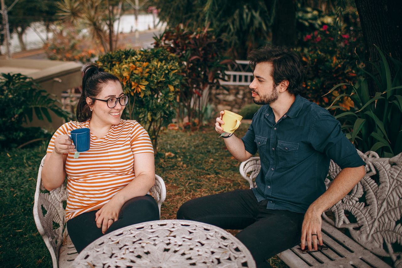 Two friends having coffee and a genuine conversation outdoors